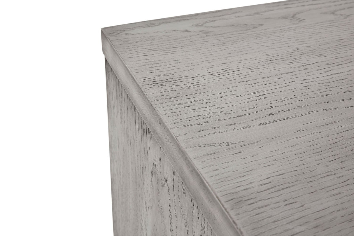 Close-up of a light gray wood grain surface with a visible corner edge and side panel, shown against a white background.