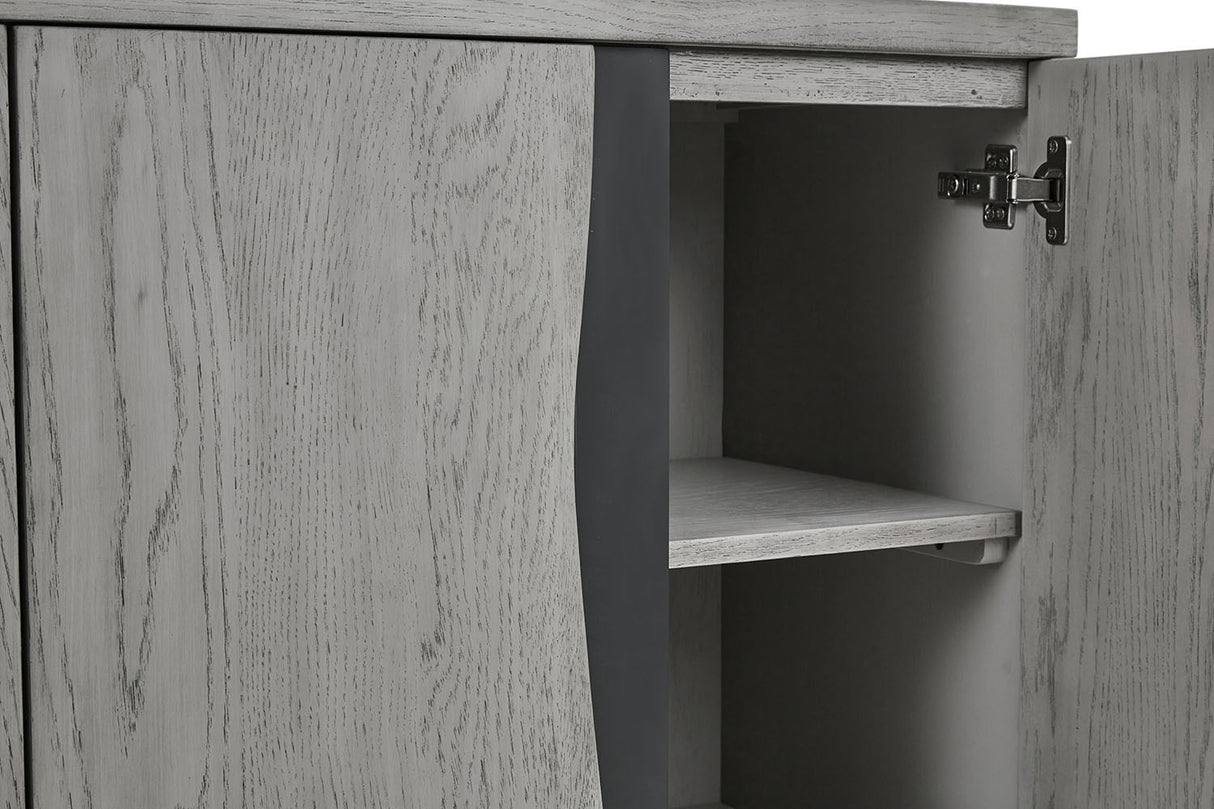 Close-up of a light gray wood cabinet with one door open, showing the interior shelf and dark gray side panel.