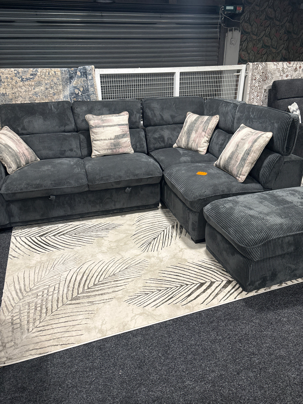 Shop display Grey sofa bed corner suite with ottoman footstool