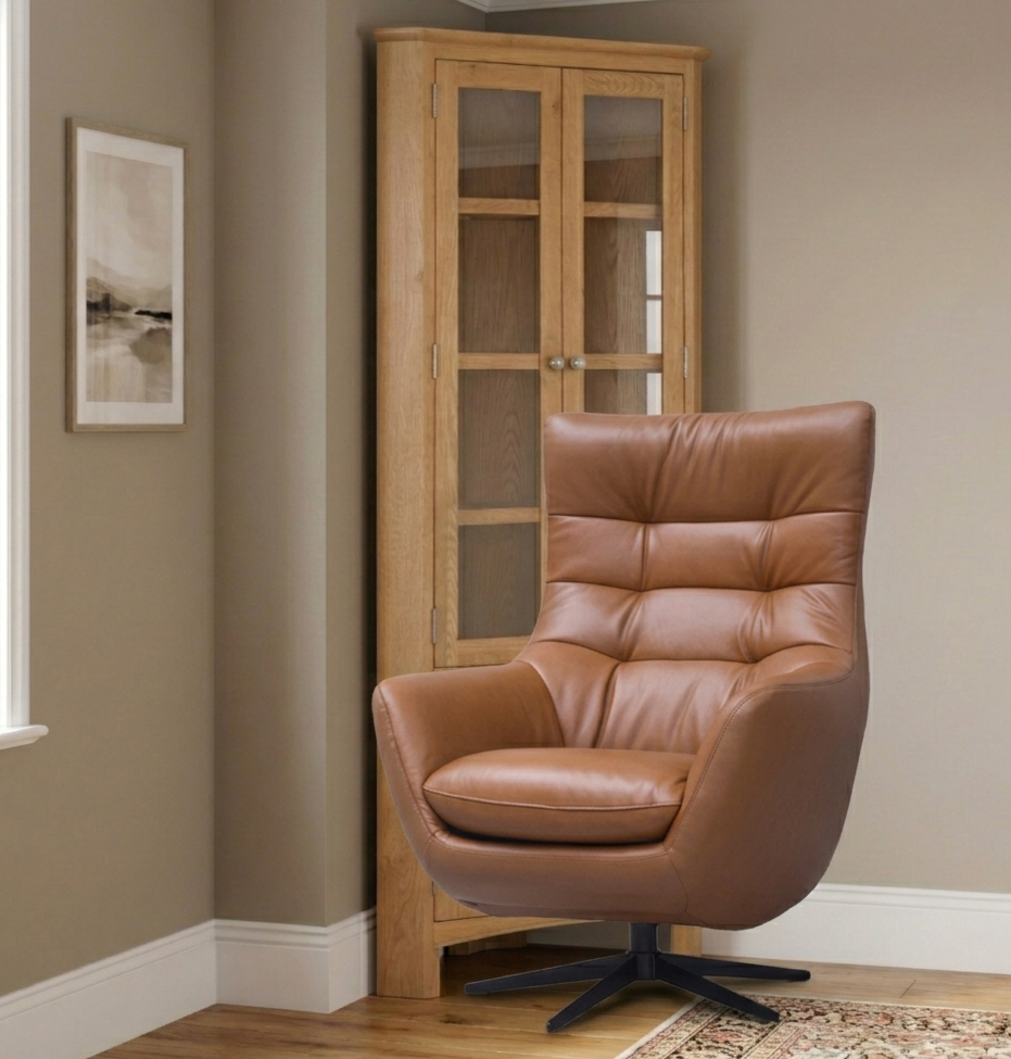Orbit Luxury Swivel Chair upholstered in premium, rich saddle tan genuine leather, showcasing its high-back cushioned design and sleek black star swivel base at furniture store ni