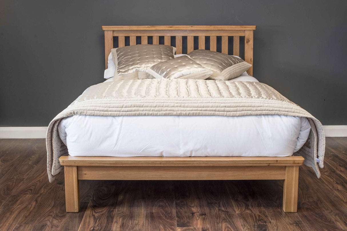 Manhattan solid oak bed frame with a natural wax finish, showcasing the rich wood grain and sturdy hand-crafted structure furniture store ni