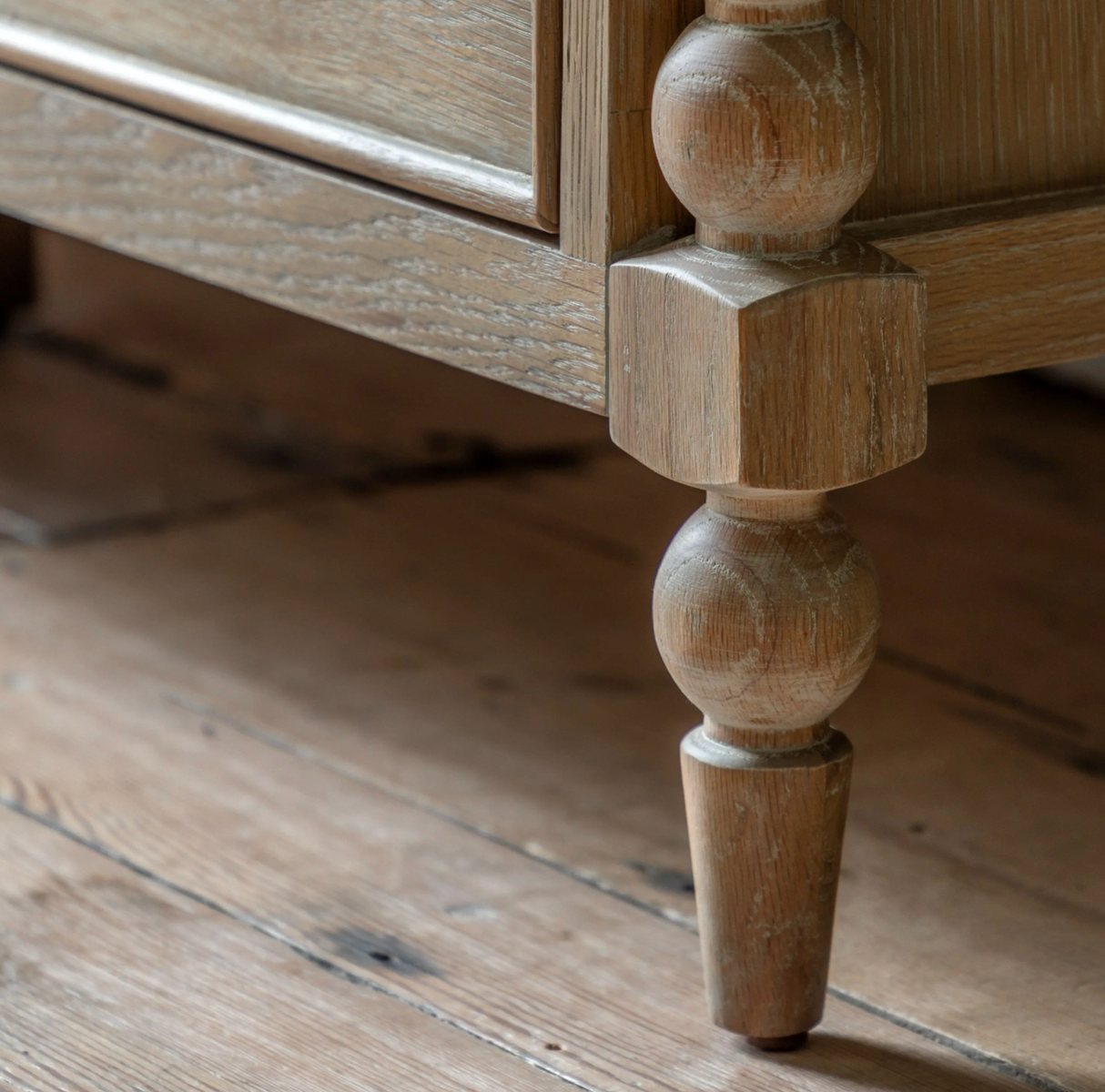 Close-up of a wooden furniture leg on a rustic wooden floor at the furniture store ni