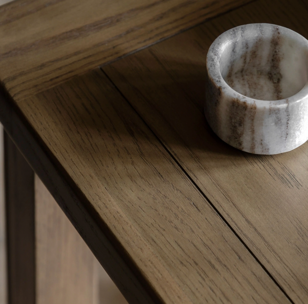 Hardwick square oak side table showcasing its warm natural oak wood grain finish, robust solid construction, and practical lower storage shelf at the furniture store ni
