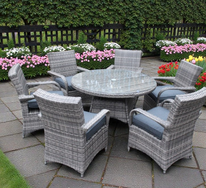 Majorca 6-seater garden dining set featuring a glass-top rattan table and six comfortable armchairs with grey cushions on a patio at furniture store ni