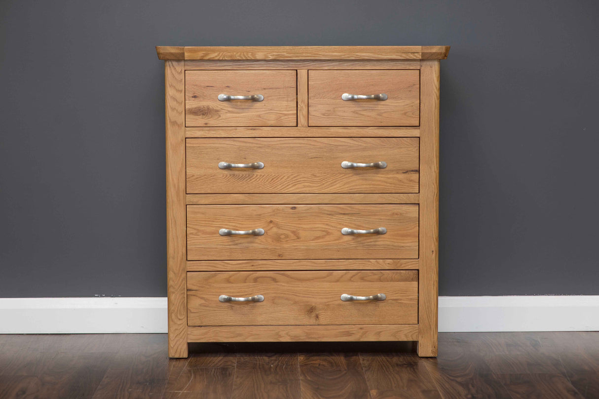 Manhattan 5-drawer chest in hand-crafted solid oak with modern chrome handles and natural wax finish.