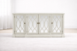 Modena 4-door sideboard featuring mirrored glass panels and an elegant repeating oval weave wood frame in a modern living room setting. furniture store ni