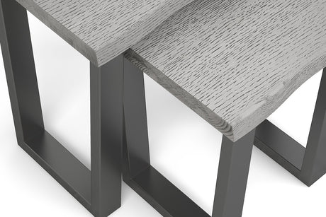 Close-up of a modern table with a light gray wood grain top and dark charcoal metal legs, shown on a white background.