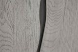 Close-up of a light gray woodgrain surface with a dark curved slit or gap running vertically through the center.