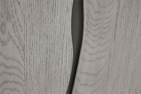 Close-up of a light gray woodgrain surface with a dark curved slit or gap running vertically through the center.