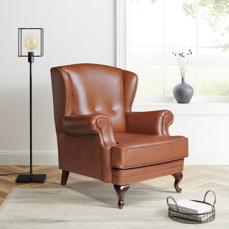 Dark brown leather wing chair with brass stud detailing