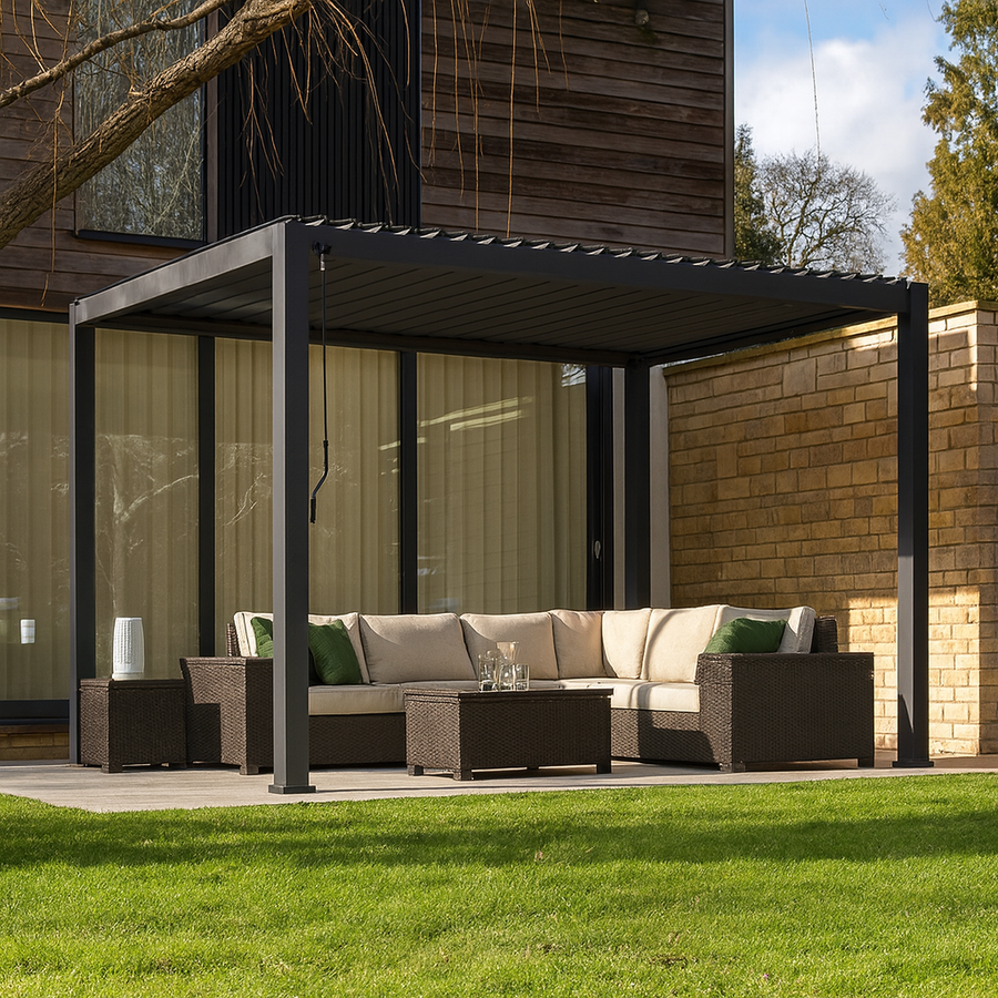 Graphite grey Titan aluminium pergola installed on a modern paved patio, featuring parallel integrated LED strip lighting across the louvred roof at furniture store ni
