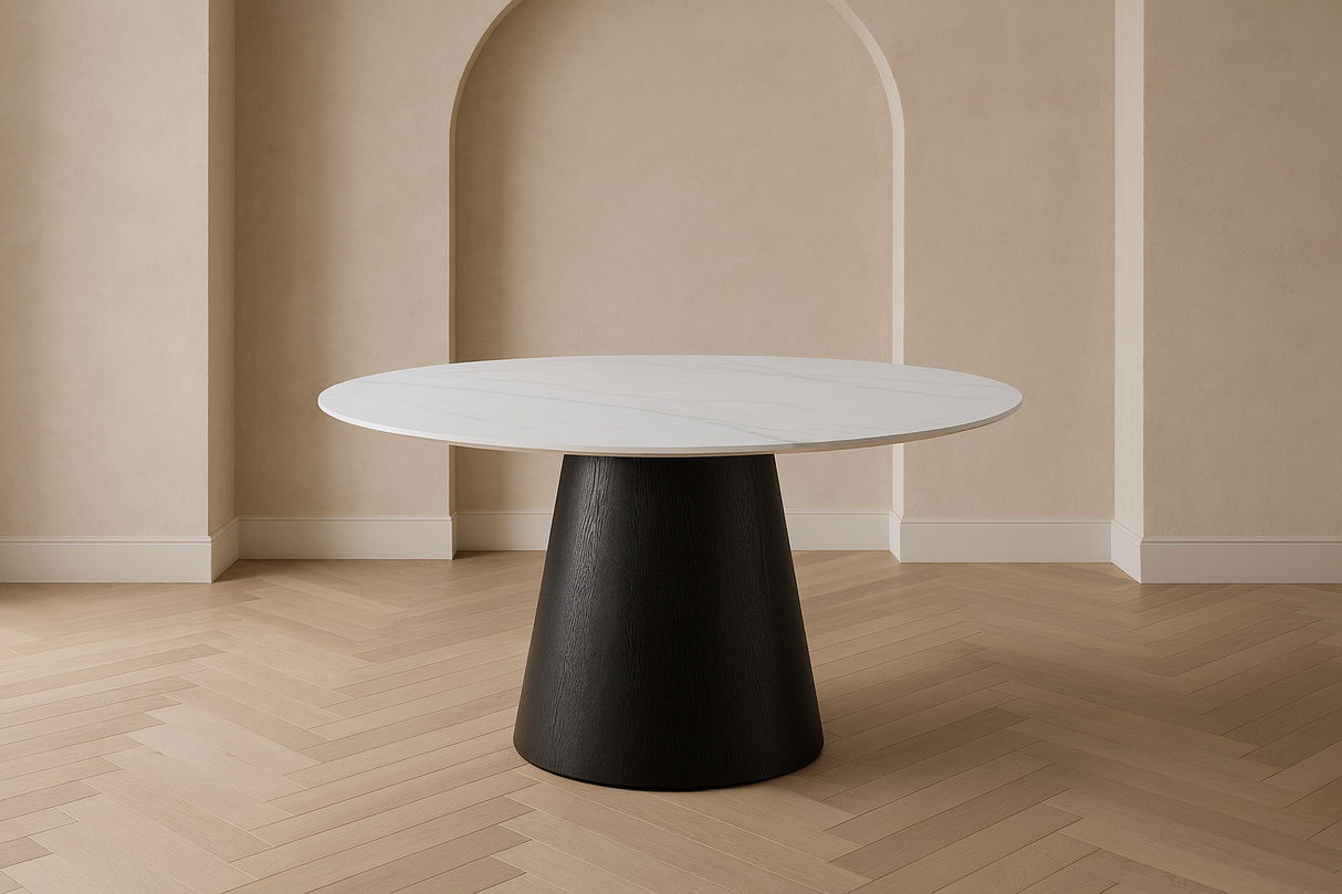Round white table with a black base in a minimalistic room with beige walls and wooden floor at the furniture store ni