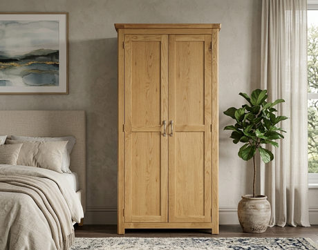 manhattan oak wardrobe in a bedroom with a bed, plant, and painting at the furniture store ni