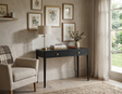 Acton 2-drawer console table showcasing its rich black finish, slender architectural silhouette, and elegant contrasting gold handles at the furniture store ni