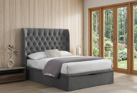 Clara gas lift storage bed in chic Grey fabric, featuring a beautifully tufted buttoned headboard in a bright, minimalist bedroom setting at the furniture store ni