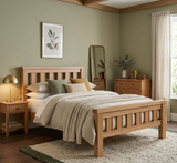 Newbury light oak bedframe in a bright, modern bedroom, highlighting the natural oak finish and clean lines at the furniture store ni