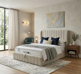 Frida storage bedframe in beige plush fabric, showcasing an elegant wingback headboard with vertical lines and a gas-lift base at the furniture store ni