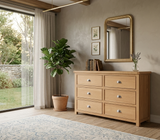 newbury oak dresser with a mirror in a room with a sliding glass door and potted plant at the furniture store ni