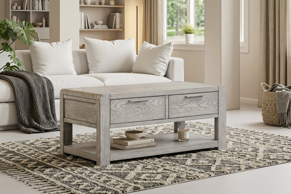 Amsterdam grey washed oak 2-drawer coffee table showcasing its 115cm wide rectangular surface, subtle grey-washed oak grain finish, and two front storage drawers at the furniture store ni