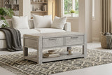 Amsterdam grey washed oak 2-drawer coffee table showcasing its 115cm wide rectangular surface, subtle grey-washed oak grain finish, and two front storage drawers at the furniture store ni