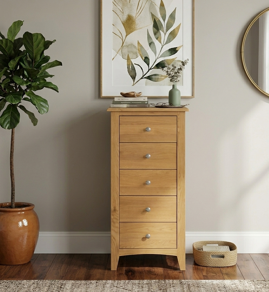 Kilkenny 5-drawer narrow solid oak chest, showcasing its vertical space-saving profile, curved top, and sleek chrome handles in a modern bedroom corner at furniture store ni