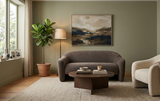 Arona minimalist sculptural 2-seater sofa with smooth curved edges and gentle contours, styled in a bright, high-end neutral living room alcove the furniture store ni