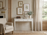 Acton 2-drawer console table showcasing its clean white finish, slender architectural silhouette, and elegant contrasting gold handles at the furniture store ni
