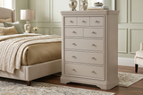hop the Mabel 8-drawer tall chest. Features a robust structure, elegant taupe painted finish, silver handles, and gorgeous curves for vertical luxury storage at the furniture store ni