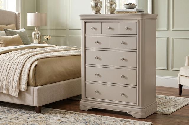 hop the Mabel 8-drawer tall chest. Features a robust structure, elegant taupe painted finish, silver handles, and gorgeous curves for vertical luxury storage at the furniture store ni
