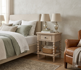 Artisan 1-drawer bedside table showcasing its exquisite hand-crafted bobbin turned legs, premium oak wood grain, and a subtle lime wash finish at the furniture store ni