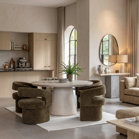 the pedra Modern 152cm round dining table with a textured Travertine finish and tapered base, crafted from Glass Reinforced Concrete for indoor and outdoor spaces at the furniture store ni