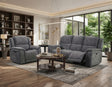 A modern living room setup featuring a gray upholstered reclining sofa and matching recliner chair, styled with a round wooden coffee table and a textured area rug on a hardwood floor.