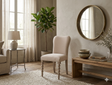 Pair of Artisan dining chairs showcasing their exquisite hand-crafted bobbin turned front legs, premium lime wash finish, and luxurious biscuit-coloured upholstered seats at the furniture store ni