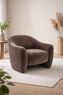 mocha armchair in a room with a light-colored rug and minimal decor at the furniture store ni