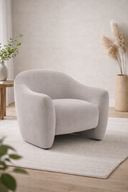 arona armchair in a minimalistic room with light-colored walls and wooden floor.