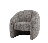 Atella contemporary tub chair in a striking black and white patterned fabric, highlighting its rounded silhouette and tailored vertical stitching at the furniture store ni
