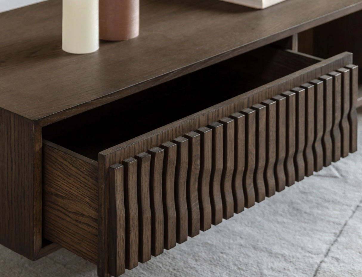 Wooden drawer with decorative front panel on a wooden surface at the furniture store ni
