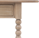 Wooden table with a drawer and decorative leg on a white background at the furniture store ni