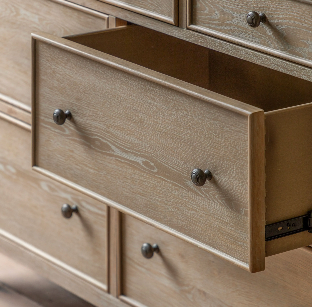 Wooden dresser with open drawer and visible hardware at the furniture store ni