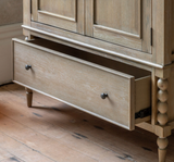 Artisan 2-door 1-drawer double wardrobe showcasing its exquisite hand-crafted bobbin turned frame details, premium oak wood grain, and a subtle lime wash finish at the furniture store ni