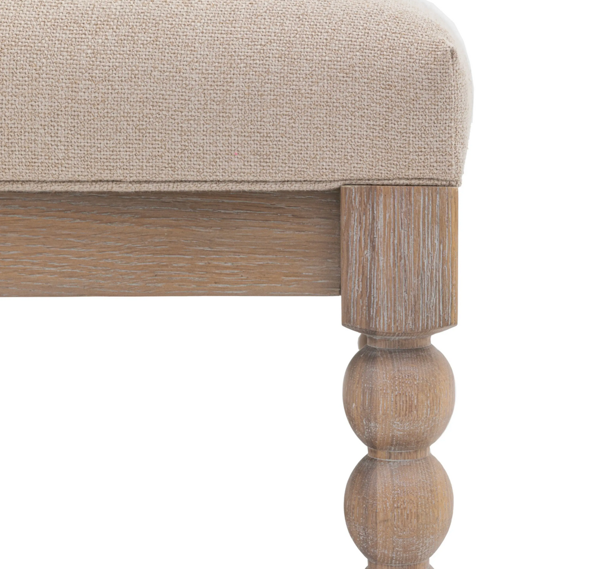 Close-up of a wooden coffee table with a beige upholstered seat on a white background at the furniture store ni