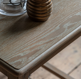 Wooden surface with a glass and a textured object on a blurred background at the furniture store ni