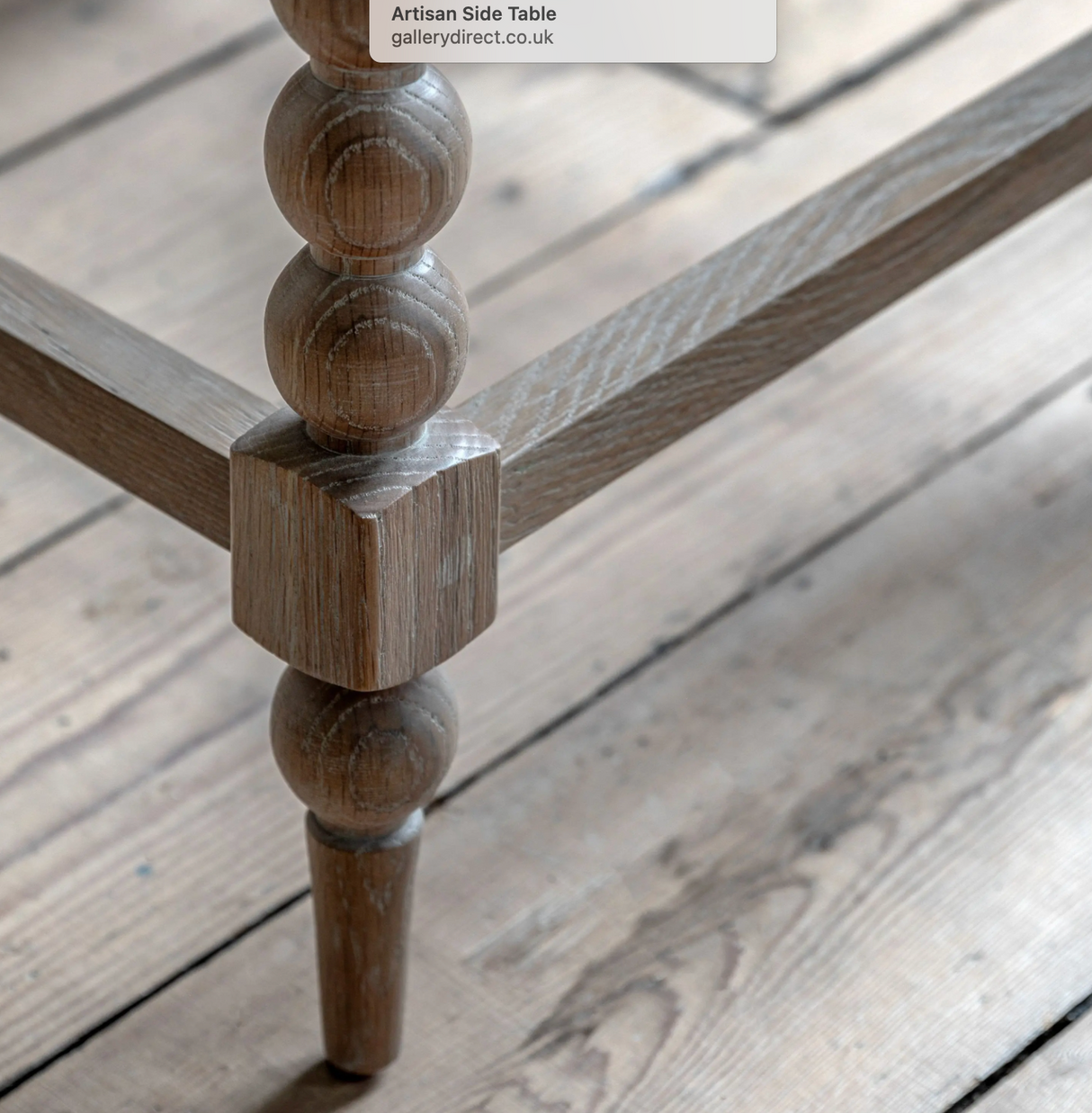 Close-up of a wooden side table leg on a wooden floor at the furniture store ni