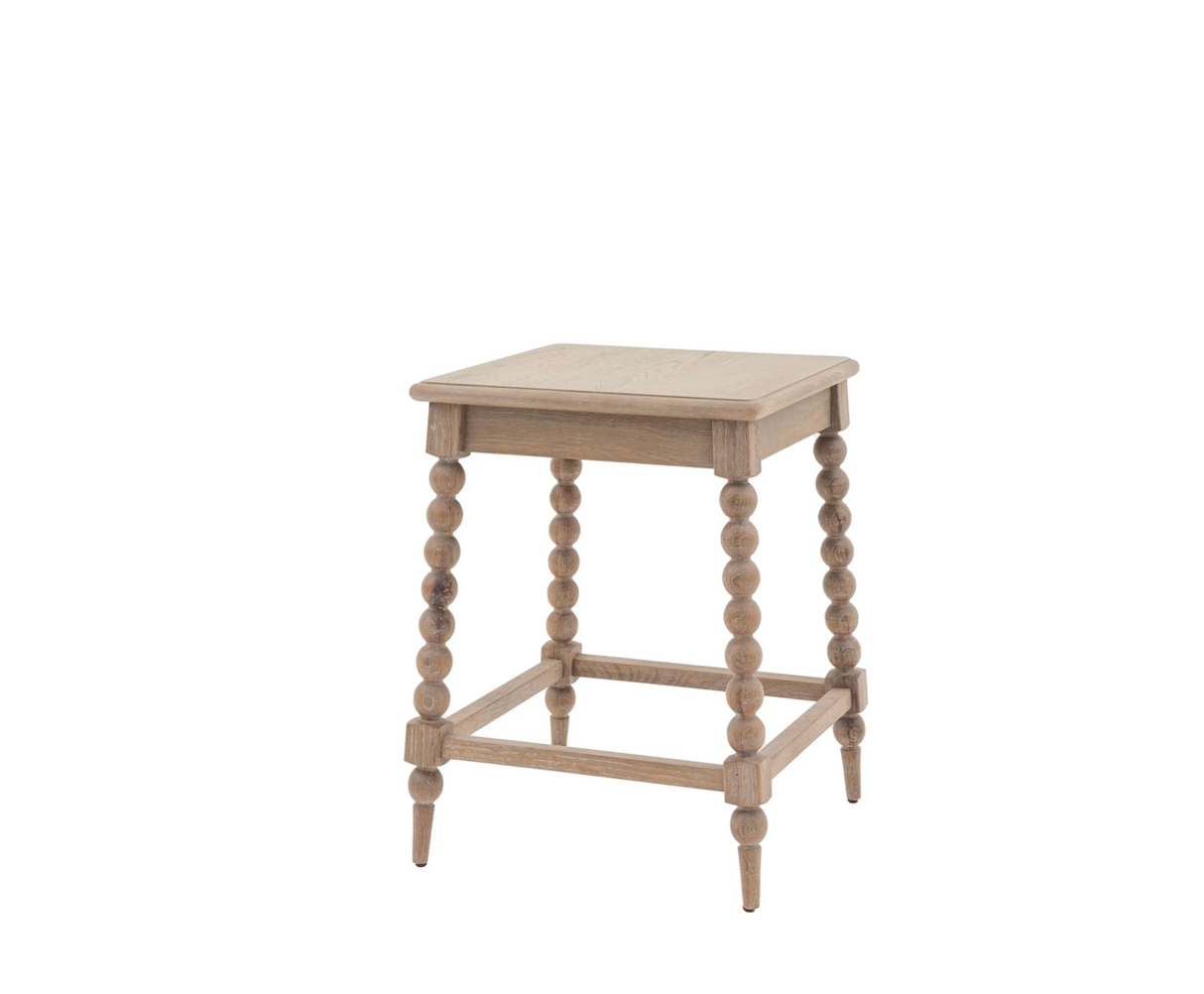 Wooden side table with spindle legs on a white background at the furniture store ni