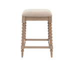 Artisan oak bar stool showcasing its exquisite hand-crafted bobbin turned legs, premium lime wash finish, and a luxurious biscuit-coloured upholstered seat at the furniture store ni