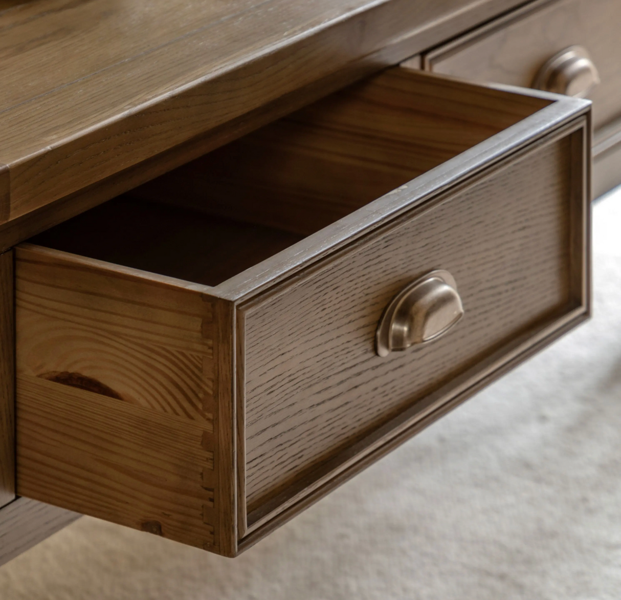 Hardwick 2-drawer coffee table showcasing its warm natural oak wood grain finish, robust solid construction, close up at the furniture store ni