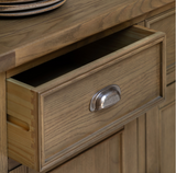 Hardwick large 3-door 3-drawer oak sideboard showcasing its expansive horizontal profile, warm natural wood grain finish, and classic metal handles at the furniture store ni