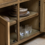 Hardwick large 3-door 3-drawer oak sideboard showcasing its expansive horizontal profile, warm natural wood grain finish, and classic metal handles at the furniture store ni