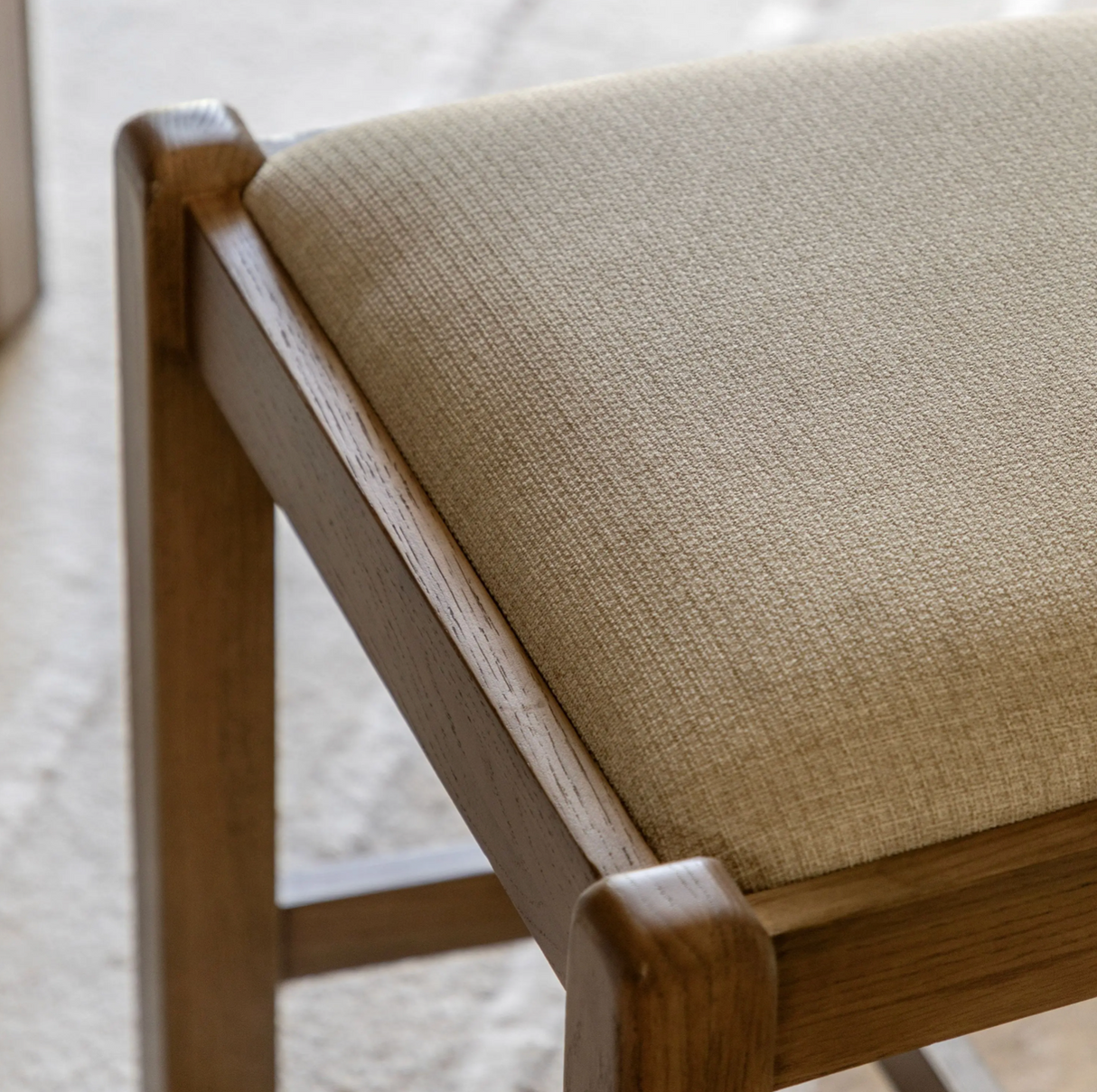 Pair of Hardwick dining chairs showcasing their warm natural oak wood grain finish, classic slatted back design, and plush neutral cushioned seats at the furniture store ni