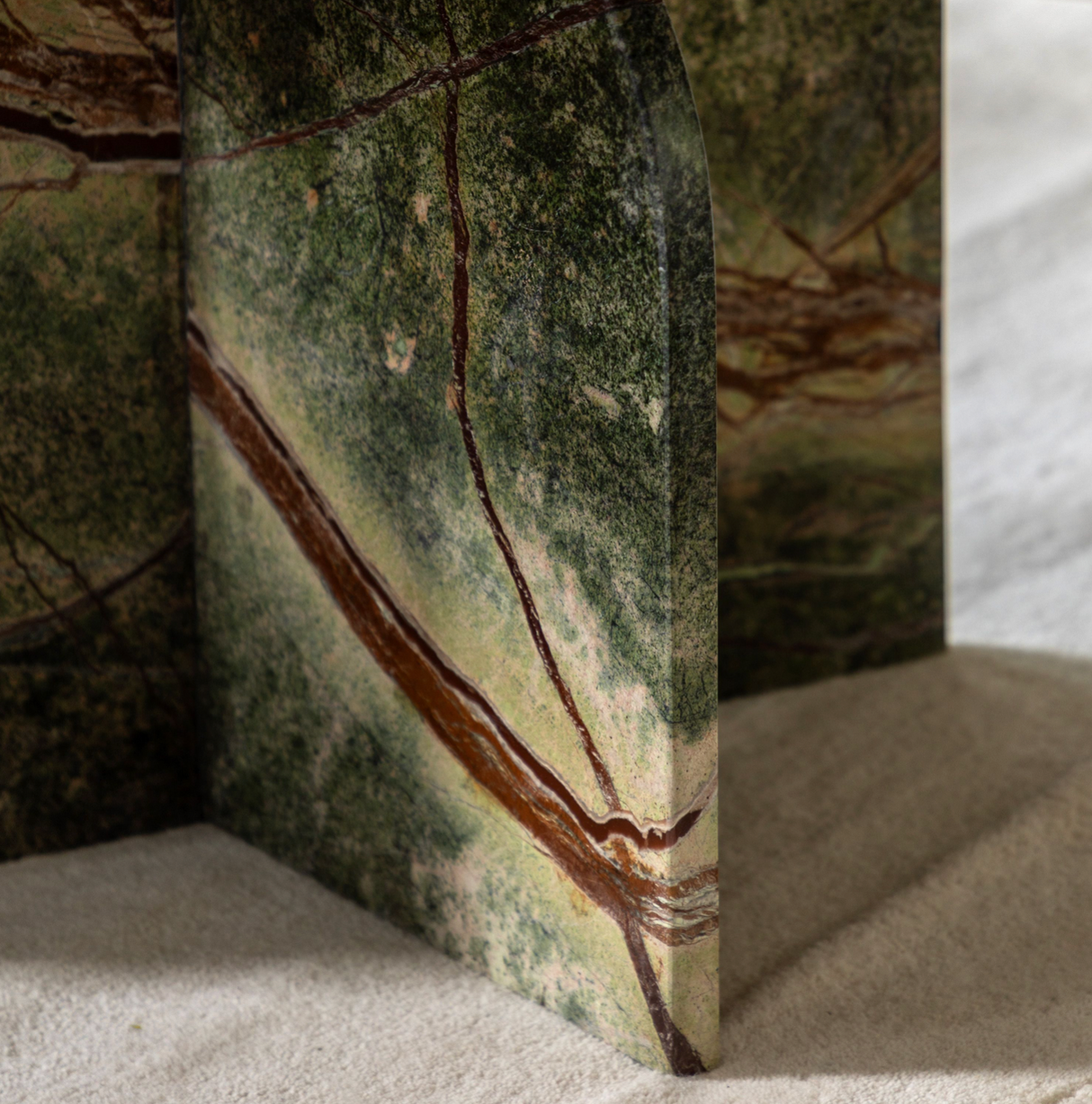 ember coffee table with brown veins on a sandy surface at the furniture sore ni